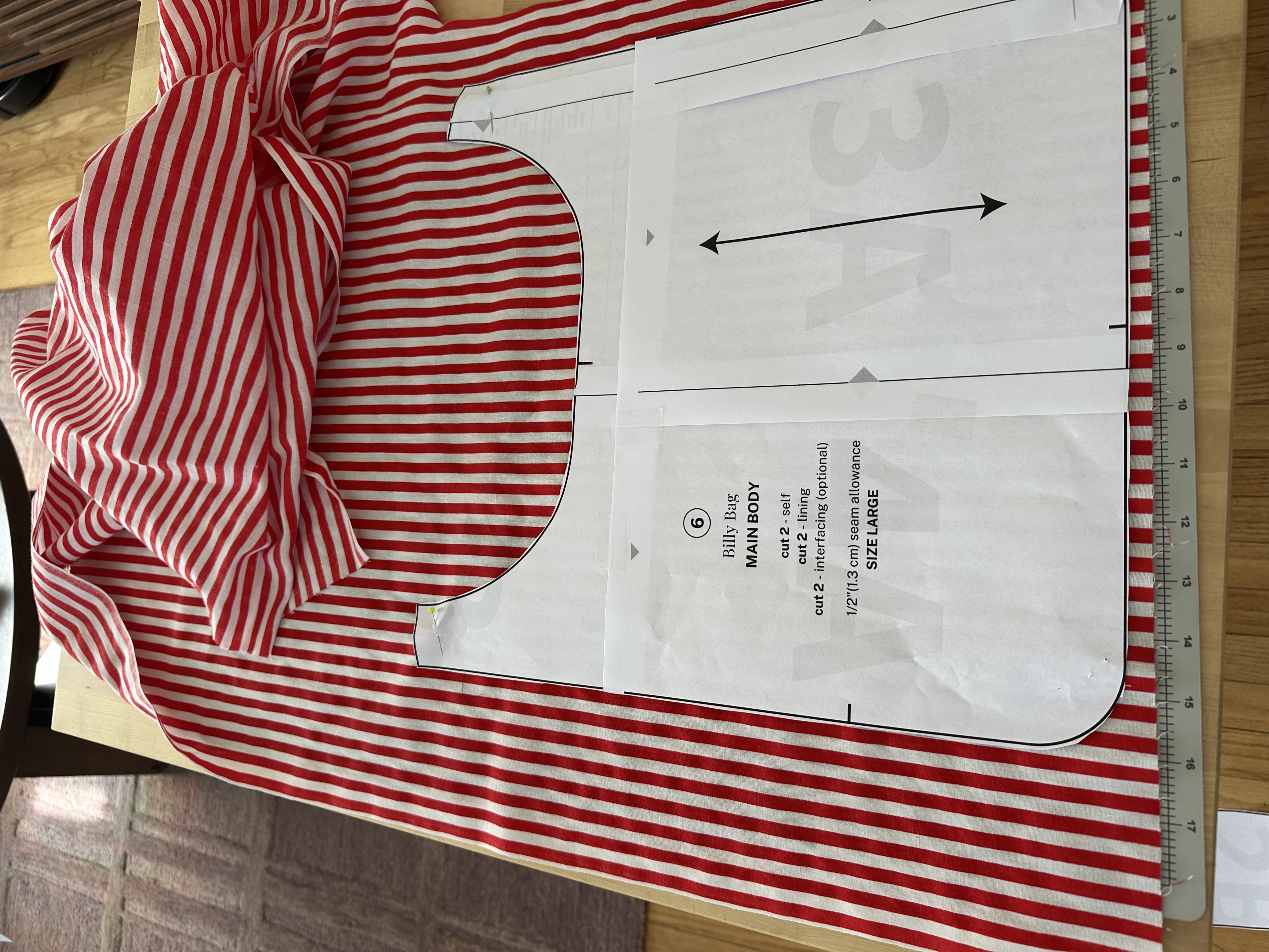 Billy Bag size large pattern piece pinned to red and white striped fabric before cutting